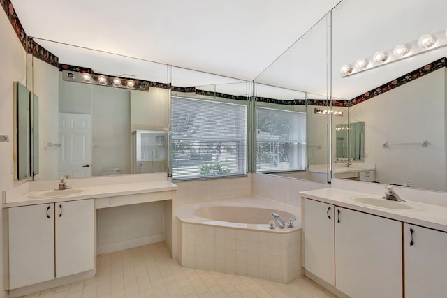 2445 Stonegate Dr, Wellington, FL 33414 - bathroom featuring a bath, two vanities, a sink, and tile patterned floors