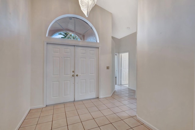 2445 Stonegate Dr, Wellington, FL 33414 - foyer entrance featuring high vaulted ceiling, baseboards, and light tile patterned floors