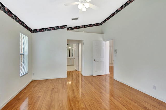 2445 Stonegate Dr, Wellington, FL 33414 - spare room featuring baseboards, light wood-type flooring, a ceiling fan, visible vents, and lofted ceiling