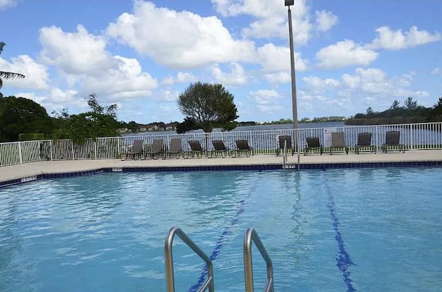 community pool featuring fence