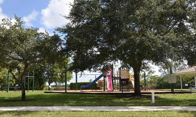 communal playground featuring a lawn