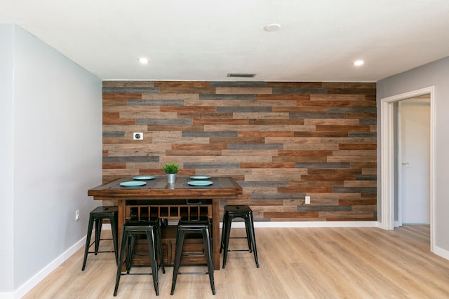 8421 NW 24th St, Sunrise, FL 33322 - dining room featuring visible vents, wood walls, an accent wall, wood finished floors, and baseboards