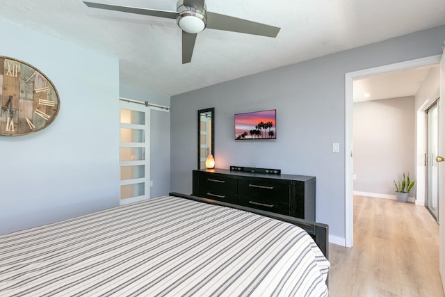 8421 NW 24th St, Sunrise, FL 33322 - bedroom featuring baseboards, ceiling fan, a barn door, and light wood-style flooring