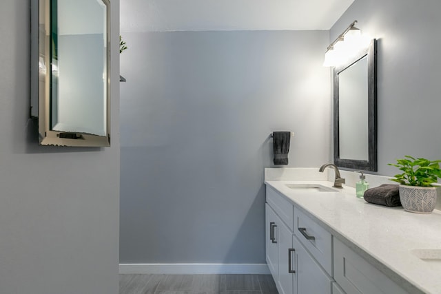 8421 NW 24th St, Sunrise, FL 33322 - bathroom featuring double vanity, baseboards, and a sink