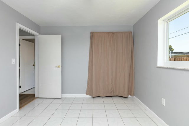 8421 NW 24th St, Sunrise, FL 33322 - unfurnished bedroom with baseboards and light tile patterned flooring