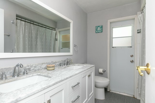 8421 NW 24th St, Sunrise, FL 33322 - bathroom featuring double vanity, a sink, and toilet