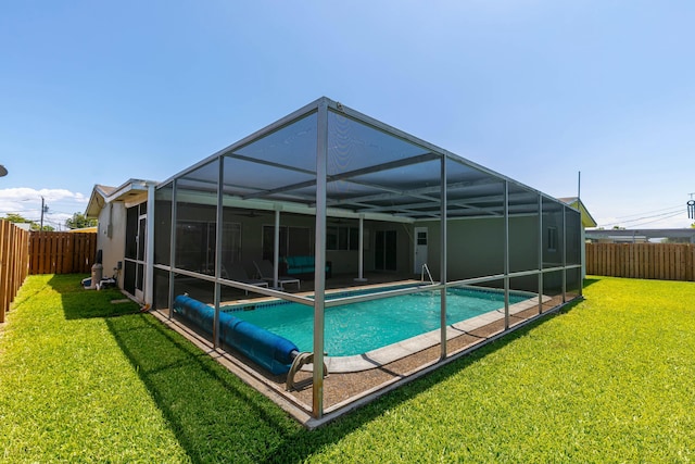 8421 NW 24th St, Sunrise, FL 33322 - rear view of property with a lawn, a fenced in pool, a fenced backyard, and glass enclosure