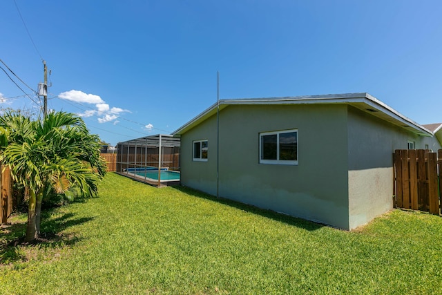 8421 NW 24th St, Sunrise, FL 33322 - view of side of home with a yard, a fenced backyard, and stucco siding