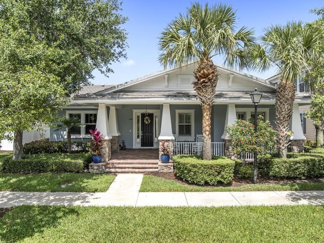 1345 Bourne Dr, Jupiter, FL 33458 - view of front of home with a porch and stucco siding
