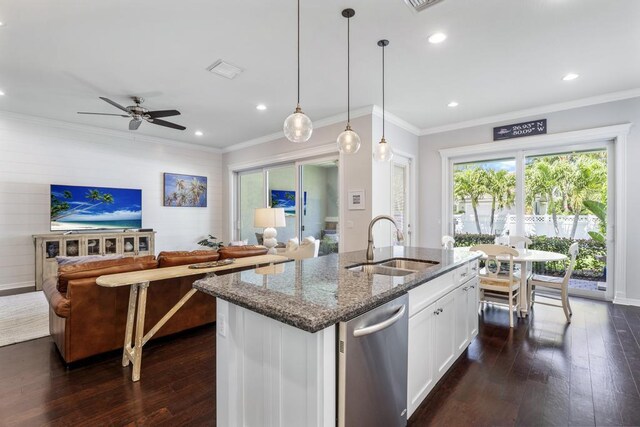 1345 Bourne Dr, Jupiter, FL 33458 - kitchen featuring crown molding, dark stone counters, dark wood-style flooring, a sink, and open floor plan