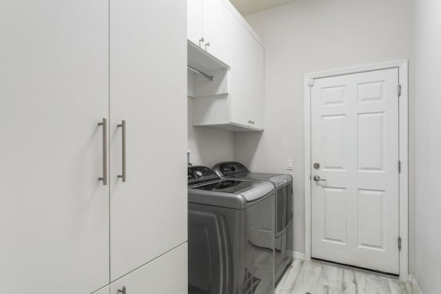 1345 Bourne Dr, Jupiter, FL 33458 - washroom featuring cabinet space, baseboards, light wood finished floors, and washer and dryer