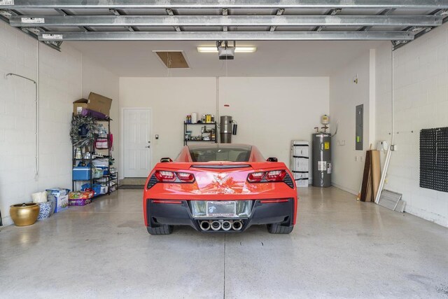 1345 Bourne Dr, Jupiter, FL 33458 - garage with electric water heater, electric panel, a garage door opener, and concrete block wall