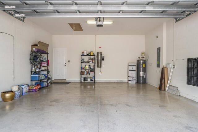 1345 Bourne Dr, Jupiter, FL 33458 - garage with electric panel, water heater, a garage door opener, and concrete block wall