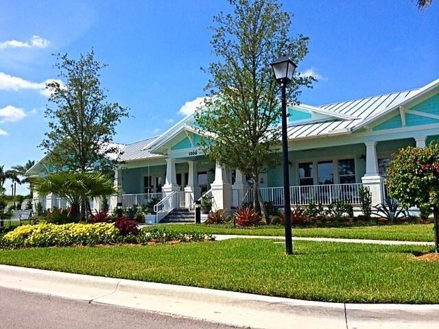 1345 Bourne Dr, Jupiter, FL 33458 - view of front of house with a standing seam roof, a porch, a front lawn, and metal roof