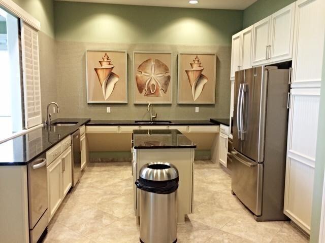 1345 Bourne Dr, Jupiter, FL 33458 - kitchen featuring a kitchen island, a peninsula, a sink, and appliances with stainless steel finishes
