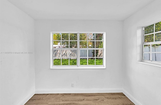 unfurnished room featuring wood finished floors and baseboards