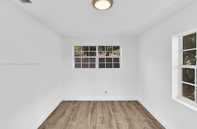empty room with wood finished floors and baseboards