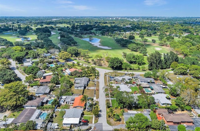 drone / aerial view featuring view of golf course and a residential view