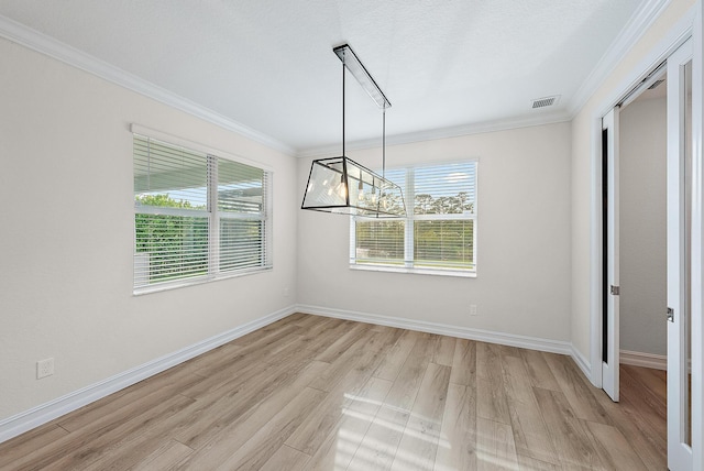 4770 SW Ardsley Dr, Stuart, FL 34997 - unfurnished dining area with crown molding, light wood finished floors, baseboards, and a chandelier