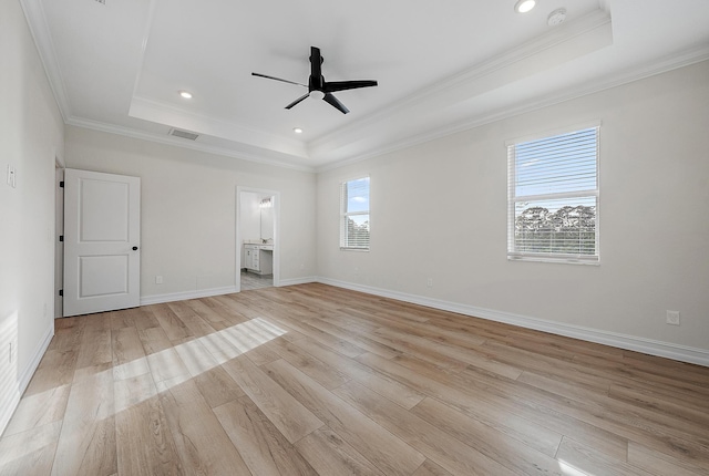 4770 SW Ardsley Dr, Stuart, FL 34997 - unfurnished bedroom featuring a raised ceiling, crown molding, light wood-type flooring, recessed lighting, and ensuite bath