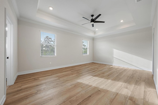 4770 SW Ardsley Dr, Stuart, FL 34997 - spare room with a tray ceiling, light wood finished floors, crown molding, ceiling fan, and baseboards