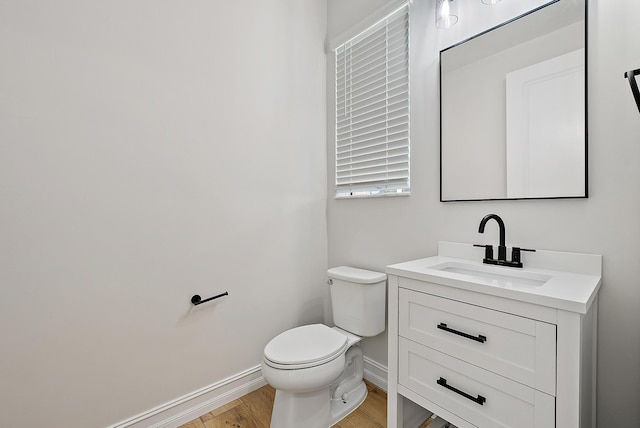 4770 SW Ardsley Dr, Stuart, FL 34997 - half bath featuring baseboards, vanity, wood finished floors, and toilet