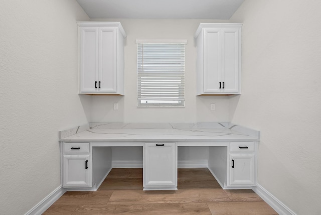 4770 SW Ardsley Dr, Stuart, FL 34997 - unfurnished office with built in study area, light wood-style floors, and baseboards