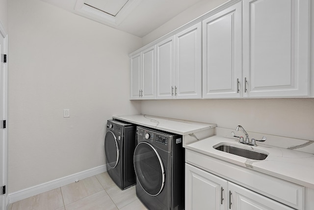 4770 SW Ardsley Dr, Stuart, FL 34997 - laundry area featuring washer and dryer, cabinet space, baseboards, and light tile patterned floors