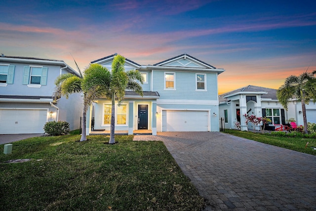 4770 SW Ardsley Dr, Stuart, FL 34997 - view of front of home featuring decorative driveway, a garage, a yard, and stucco siding