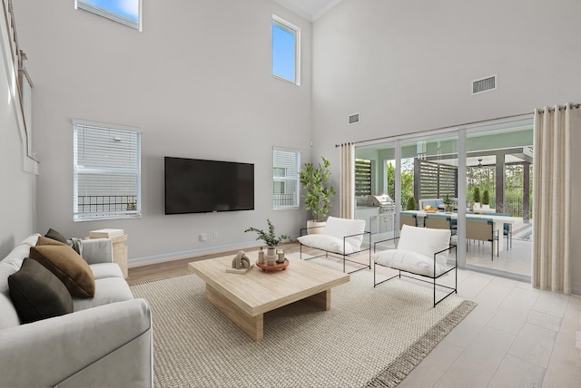 4770 SW Ardsley Dr, Stuart, FL 34997 - living room with a high ceiling, light wood-type flooring, and baseboards