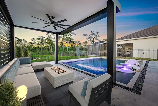 4770 SW Ardsley Dr, Stuart, FL 34997 - view of swimming pool featuring a ceiling fan, a patio, an outdoor living space with a fire pit, and a fenced backyard