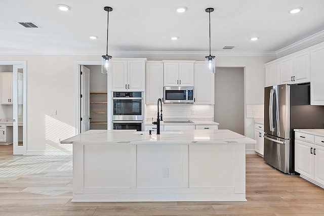 4770 SW Ardsley Dr, Stuart, FL 34997 - kitchen featuring stainless steel appliances, a sink, ornamental molding, backsplash, and white cabinets