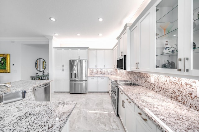 kitchen with ornamental molding, backsplash, appliances with stainless steel finishes, marble finish floor, and a sink