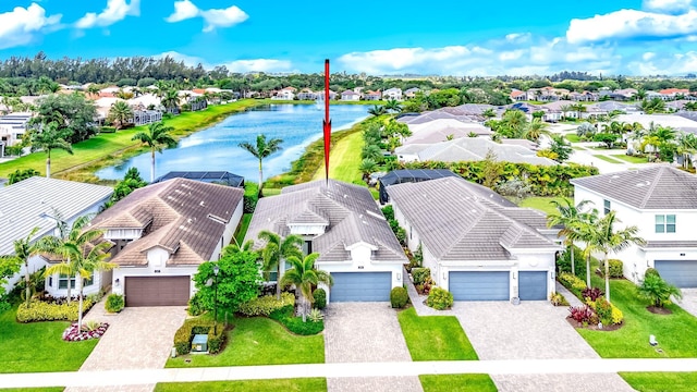birds eye view of property with a residential view and a water view