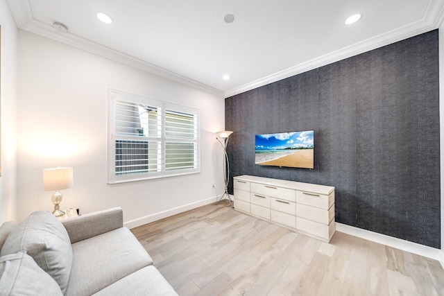 living area with baseboards, recessed lighting, crown molding, light wood-style floors, and an accent wall