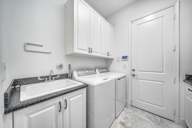 laundry area with a sink, cabinet space, washing machine and dryer, and marble finish floor
