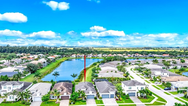 drone / aerial view with a residential view and a water view