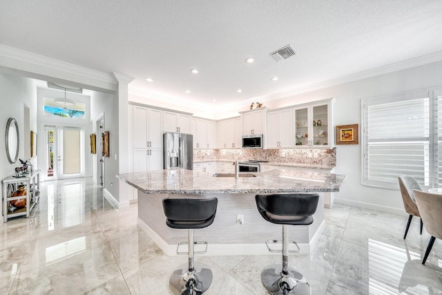 kitchen featuring visible vents, baseboards, marble finish floor, and stainless steel appliances