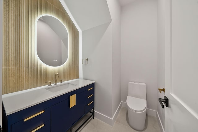 half bathroom with tile patterned flooring, decorative backsplash, toilet, vanity, and baseboards