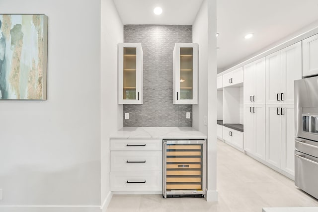 interior space featuring tasteful backsplash, recessed lighting, stainless steel fridge with ice dispenser, beverage cooler, and light tile patterned floors