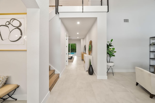 corridor featuring stairway, visible vents, recessed lighting, and baseboards
