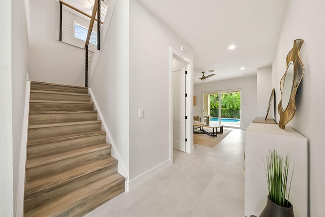 staircase featuring recessed lighting, a ceiling fan, and baseboards