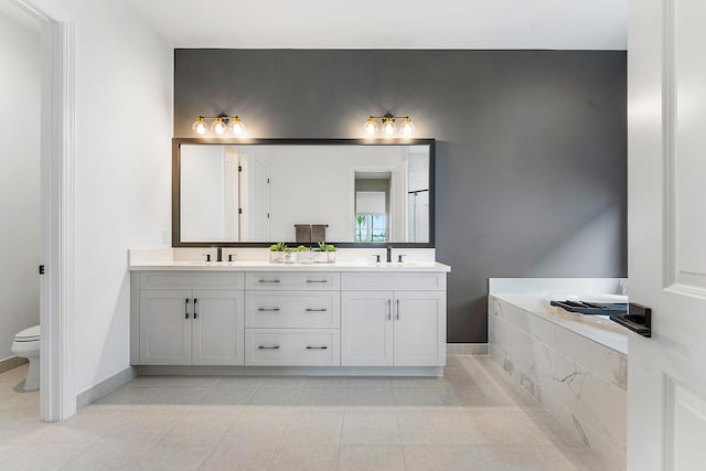 12618 Nautilus Cir, Palm Beach Gardens, FL 33412 - bathroom featuring double vanity, baseboards, a sink, and toilet