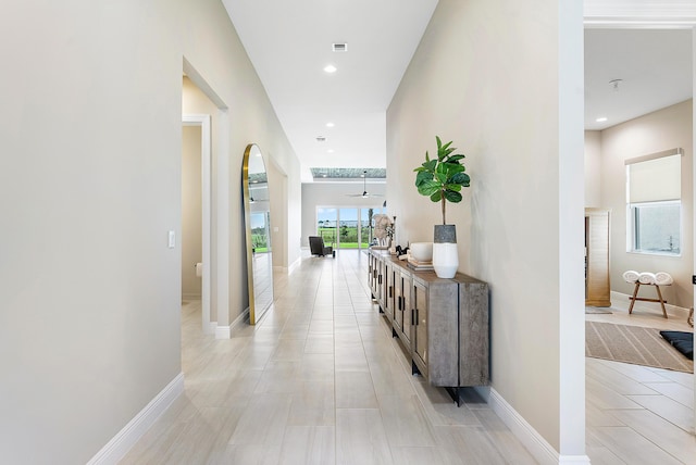 12618 Nautilus Cir, Palm Beach Gardens, FL 33412 - corridor with arched walkways, baseboards, and recessed lighting