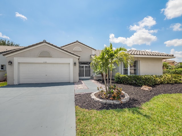 8540 Lake Cypress Rd, Lake Worth, FL 33467 - view of front facade with an attached garage, a tiled roof, driveway, and stucco siding