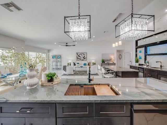 8540 Lake Cypress Rd, Lake Worth, FL 33467 - kitchen with visible vents, a sink, an inviting chandelier, and a kitchen island