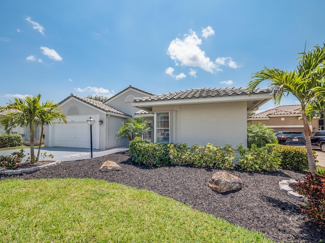 8540 Lake Cypress Rd, Lake Worth, FL 33467 - view of front facade featuring a tile roof, an attached garage, driveway, and stucco siding
