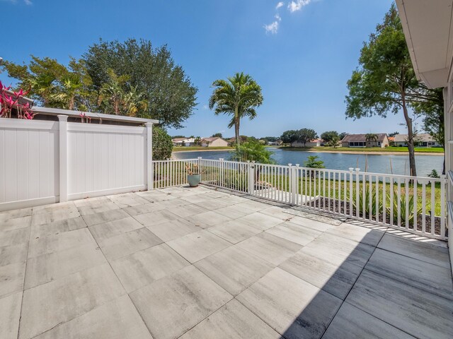 8540 Lake Cypress Rd, Lake Worth, FL 33467 - view of patio / terrace featuring fence and a water view