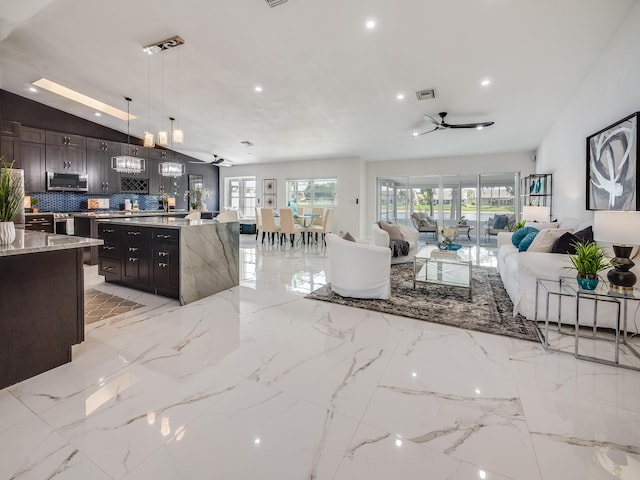 8540 Lake Cypress Rd, Lake Worth, FL 33467 - living area featuring visible vents, a wealth of natural light, a ceiling fan, and vaulted ceiling