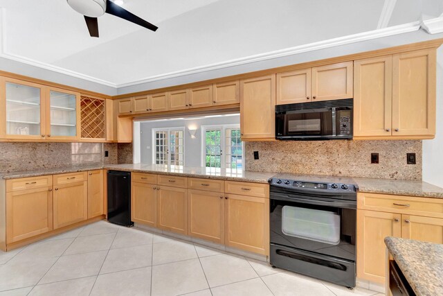 kitchen with glass insert cabinets, decorative backsplash, black appliances, and light brown cabinetry